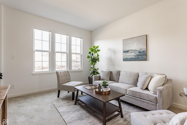 living room featuring baseboards and light colored carpet