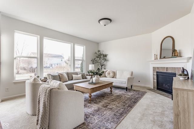 living area featuring baseboards, carpet floors, and a brick fireplace