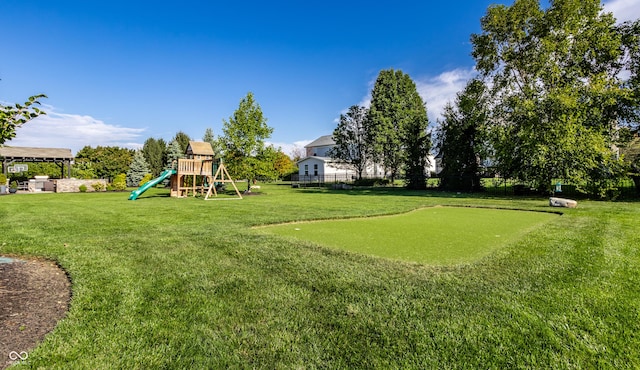 view of yard featuring a playground and fence