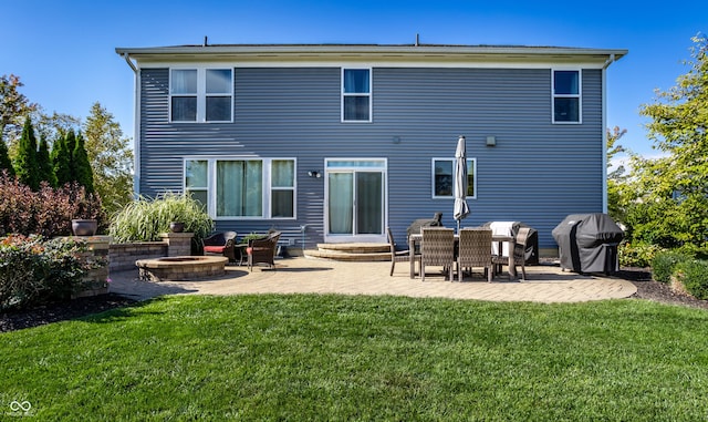 rear view of property with entry steps, a patio, and a yard