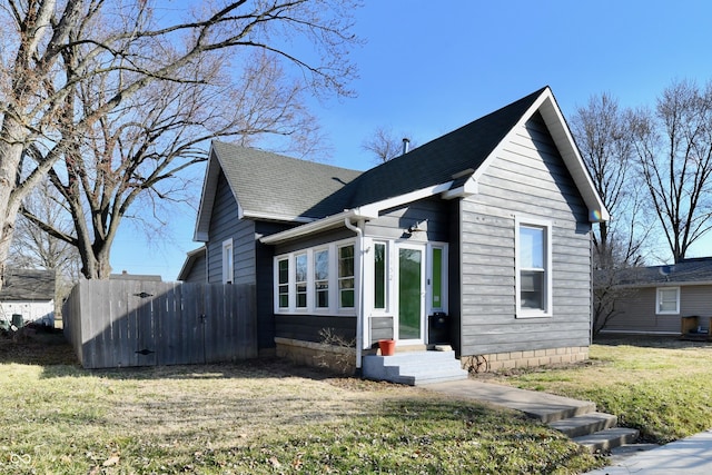 view of front of home with a gate, a shingled roof, a front lawn, and entry steps