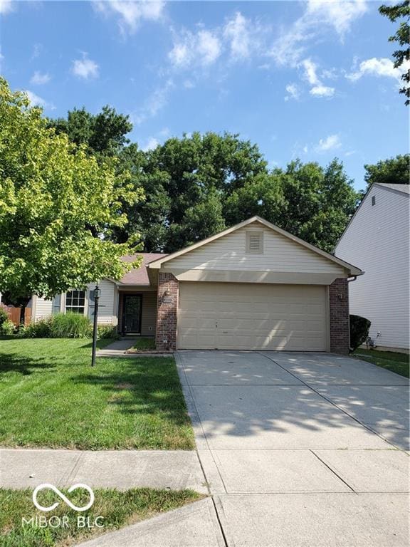 single story home featuring a front yard, concrete driveway, brick siding, and an attached garage