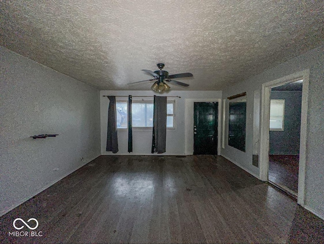 unfurnished room featuring ceiling fan, a textured ceiling, and wood finished floors