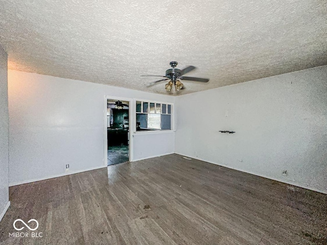 empty room with a textured ceiling, a ceiling fan, and wood finished floors