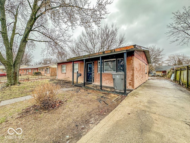 view of front of home with fence and brick siding