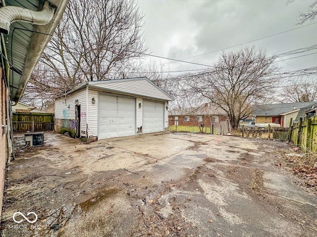 detached garage featuring fence