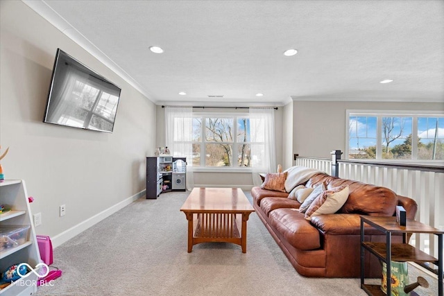 living area featuring baseboards, recessed lighting, a textured ceiling, crown molding, and light colored carpet