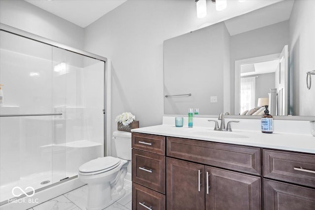 bathroom featuring vanity, toilet, marble finish floor, and a shower stall