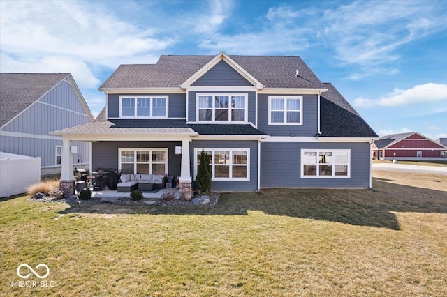 back of house featuring a shingled roof, a patio, a lawn, and an outdoor hangout area