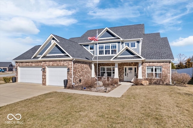 craftsman-style house with a front lawn, concrete driveway, a garage, and roof with shingles