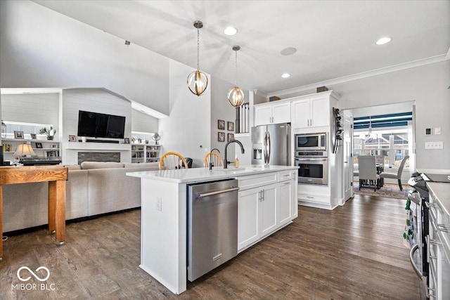 kitchen featuring a kitchen island with sink, dark wood-style floors, white cabinetry, stainless steel appliances, and light countertops