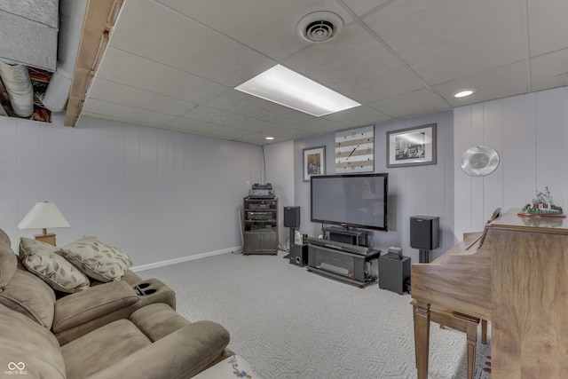 carpeted living room with visible vents, a paneled ceiling, and baseboards