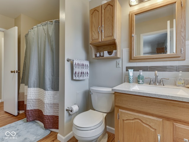 full bathroom featuring vanity, a shower with curtain, toilet, and wood finished floors