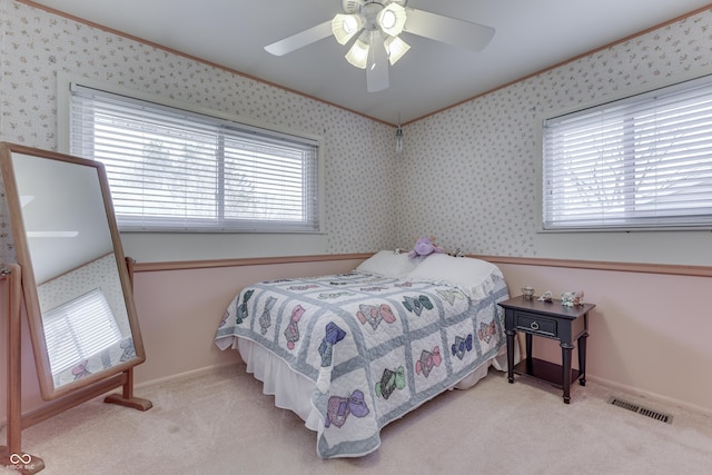 bedroom with visible vents, carpet, ornamental molding, and wallpapered walls