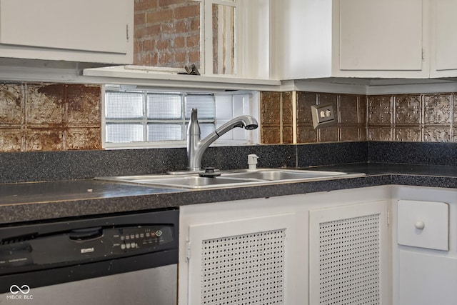 kitchen with a sink, dishwashing machine, dark countertops, and white cabinetry