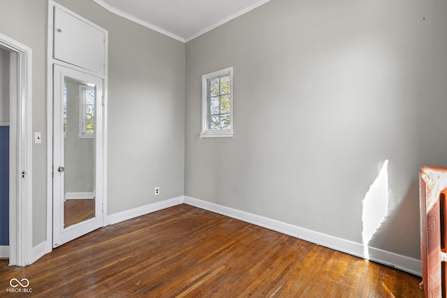 unfurnished bedroom with dark wood finished floors, baseboards, and ornamental molding