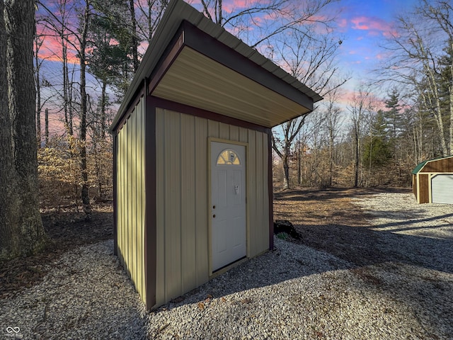 outdoor structure at dusk featuring a storage shed and an outdoor structure