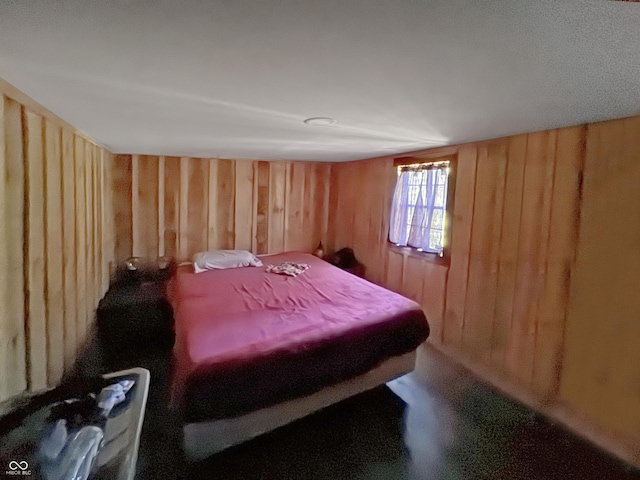 bedroom featuring wood walls