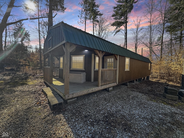 view of home's exterior with metal roof and a gambrel roof