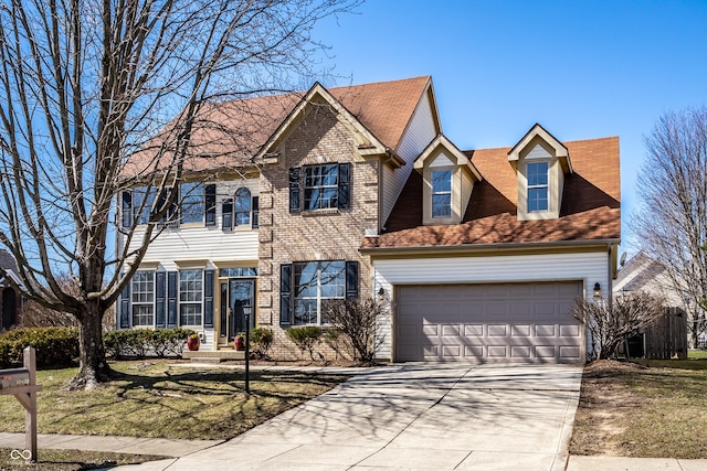 view of front of property with brick siding, driveway, and a garage