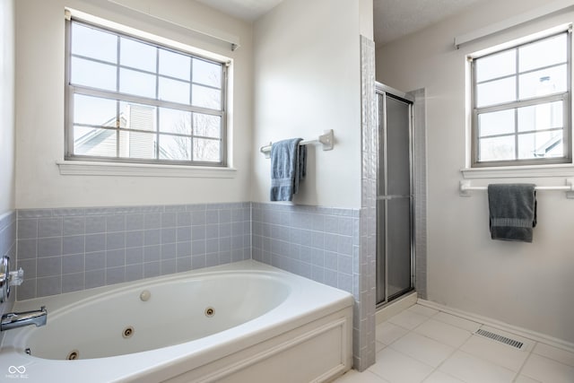 full bathroom with visible vents, a jetted tub, a shower stall, and tile patterned flooring