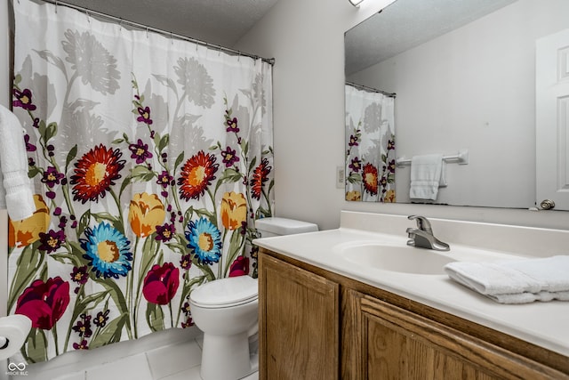 bathroom featuring vanity, toilet, tile patterned flooring, and a textured ceiling