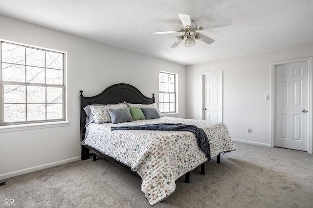 bedroom featuring a textured ceiling, baseboards, and carpet floors