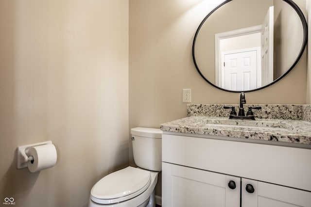 half bath with vanity and toilet