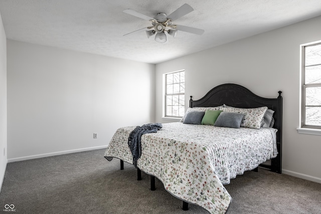 bedroom featuring baseboards, a textured ceiling, and carpet flooring