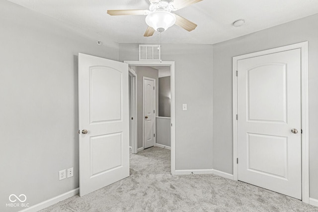 unfurnished bedroom featuring carpet flooring, baseboards, visible vents, and ceiling fan