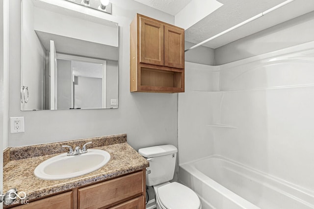 full bath with toilet, bathtub / shower combination, vanity, and a textured ceiling