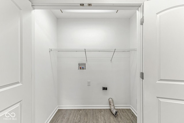 laundry area featuring wood finished floors, baseboards, hookup for an electric dryer, laundry area, and washer hookup