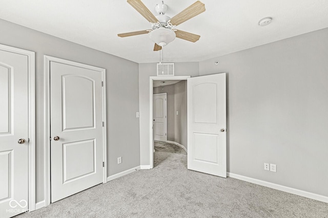 unfurnished bedroom featuring visible vents, a ceiling fan, baseboards, and carpet floors