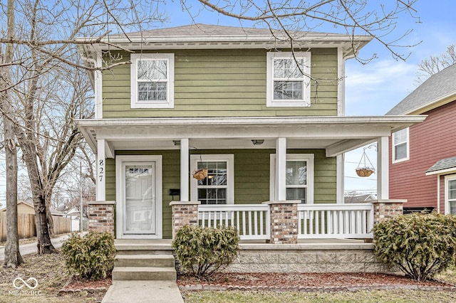 traditional style home featuring brick siding and a porch