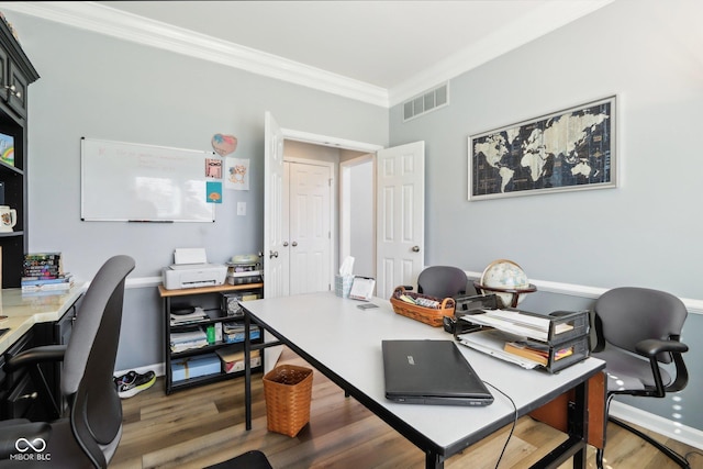 office area with visible vents, crown molding, and wood finished floors