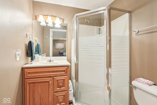 full bath featuring vanity, toilet, and a stall shower