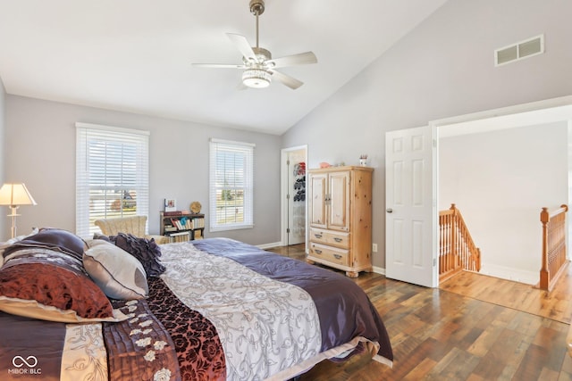 bedroom featuring visible vents, ceiling fan, baseboards, wood finished floors, and high vaulted ceiling