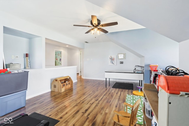 interior space featuring a ceiling fan, wood finished floors, and baseboards