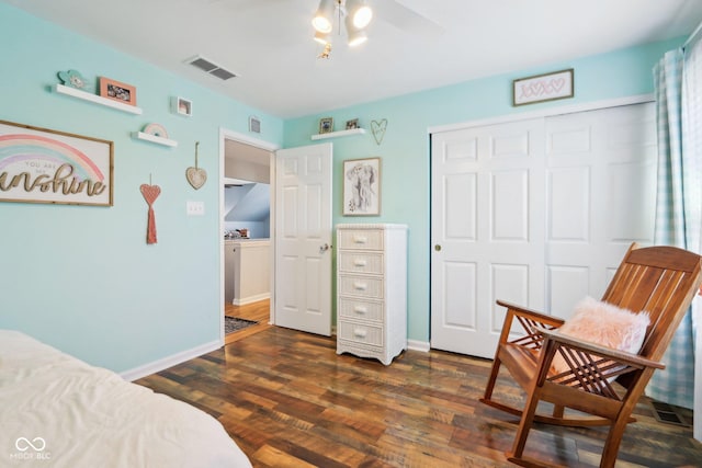 bedroom featuring a closet, baseboards, visible vents, and dark wood-style flooring