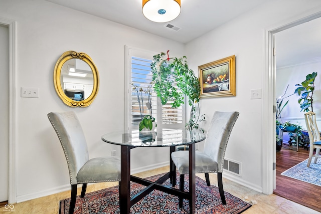 dining space featuring visible vents and baseboards