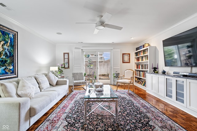 living room featuring visible vents, ornamental molding, and a ceiling fan