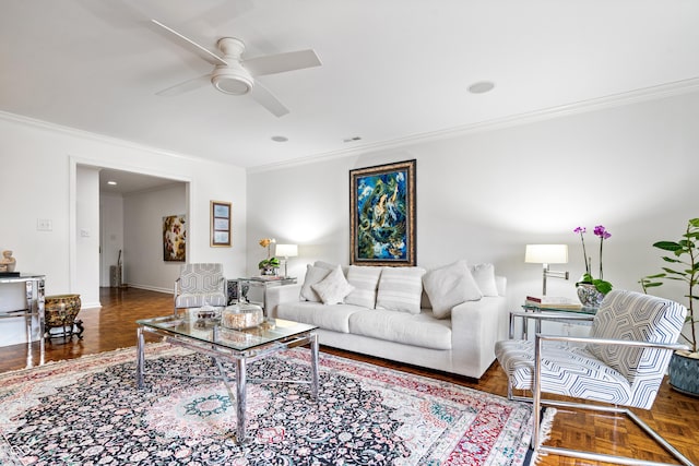 living area with visible vents, baseboards, a ceiling fan, and crown molding