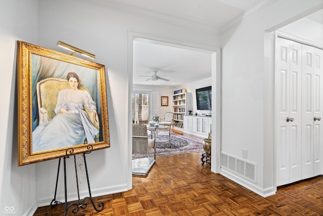 hallway with baseboards, visible vents, and ornamental molding