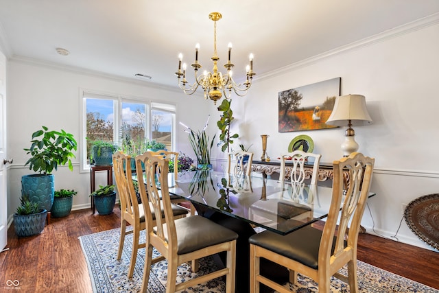 dining room featuring visible vents, a notable chandelier, wood finished floors, and ornamental molding