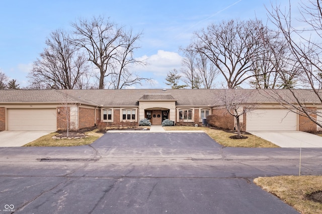 view of front of property with a garage, brick siding, and concrete driveway