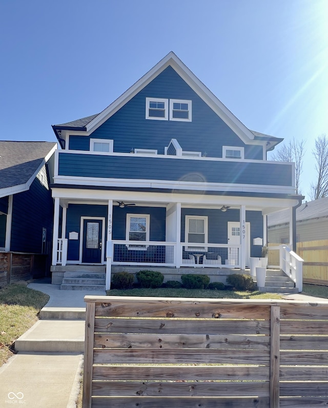 view of front of property featuring a ceiling fan, covered porch, and a fenced front yard