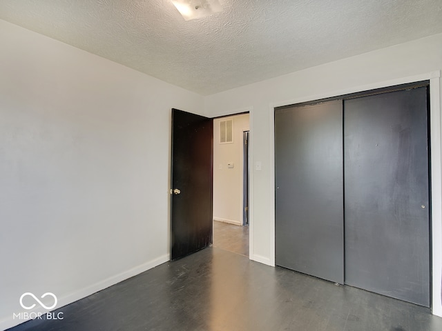 2955 Mars Hill St, Indianapolis, IN 46241 - unfurnished bedroom featuring wood finished floors, baseboards, a closet, and a textured ceiling