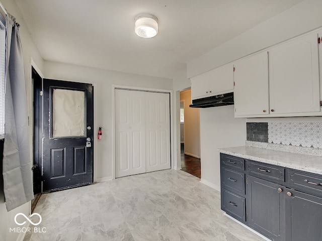 2955 Mars Hill St, Indianapolis, IN 46241 - kitchen with white cabinetry, decorative backsplash, baseboards, and under cabinet range hood