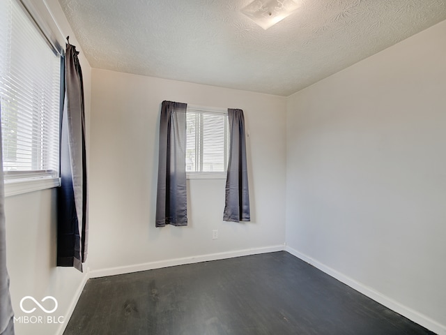 2955 Mars Hill St, Indianapolis, IN 46241 - spare room with dark wood-style flooring, a textured ceiling, and baseboards