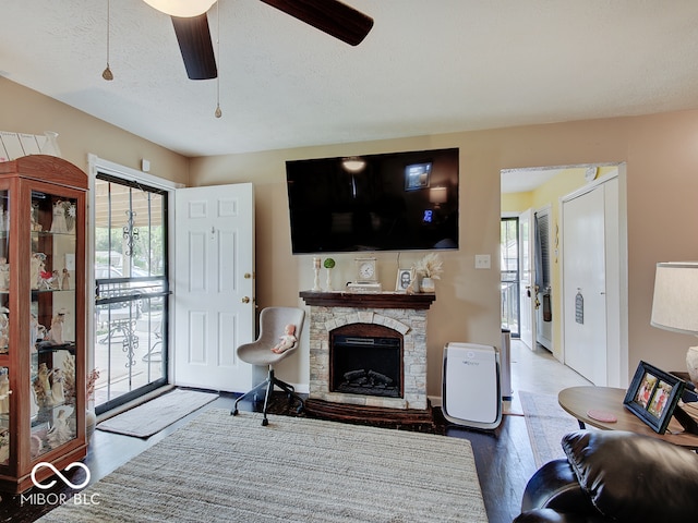 2955 Mars Hill St, Indianapolis, IN 46241 - living area featuring plenty of natural light, ceiling fan, wood finished floors, a fireplace, and a textured ceiling